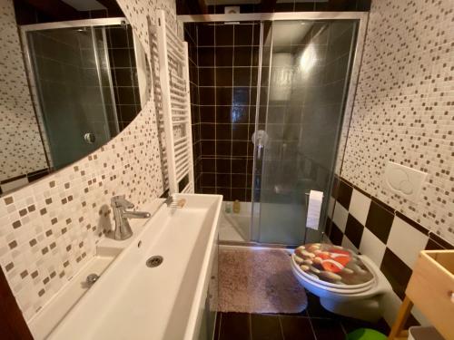 a bathroom with a sink and a shower and a toilet at Romantic maisonette in Piran