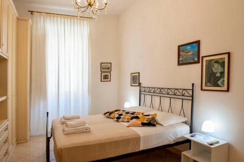 a bedroom with a bed and a chandelier at Alberto Vatican House in Rome