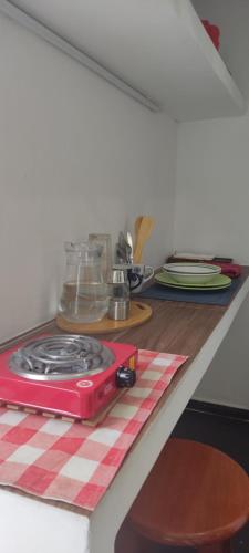 a red stove on top of a kitchen counter at La puerta azul in Coatepec