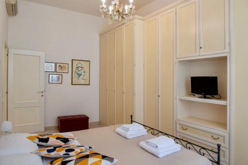 a small bedroom with a bed and a tv at Alberto Vatican House in Rome
