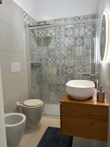 a bathroom with a shower and a toilet and a sink at All'altezza del mare in Fossacesia