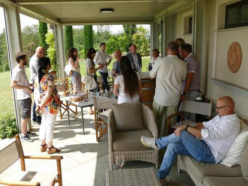 a group of people standing on a screened porch at Braida Wine Resort in Rocchetta Tanaro