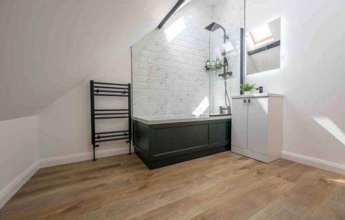 a bathroom with a sink and a bath tub at The Old School Sleeps 14 in Lymington