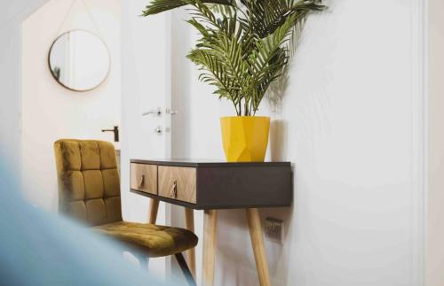 a table with a plant on top of it in a room at The Old School Sleeps 14 in Lymington
