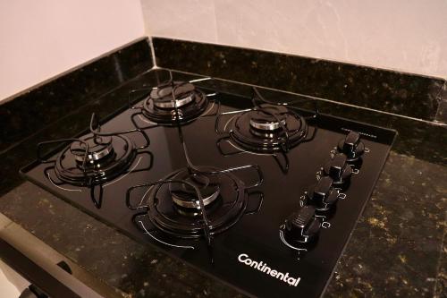 a black stove top with four burners on it at Buenos Ayres por Carpediem in Tambaú