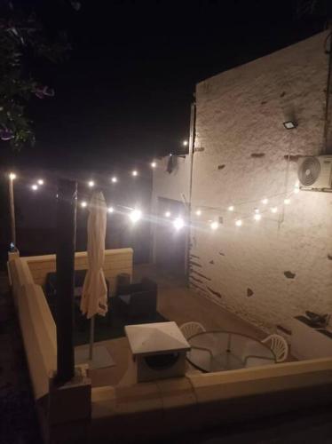 a bathroom with a tub with lights on a wall at Casa rural La calleja de las hurdes TRCC00555 in Sauceda