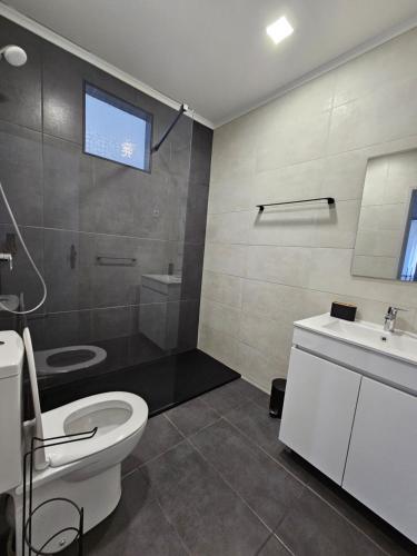a bathroom with a toilet and a sink at Residencias Ana Carmen in Viana do Castelo