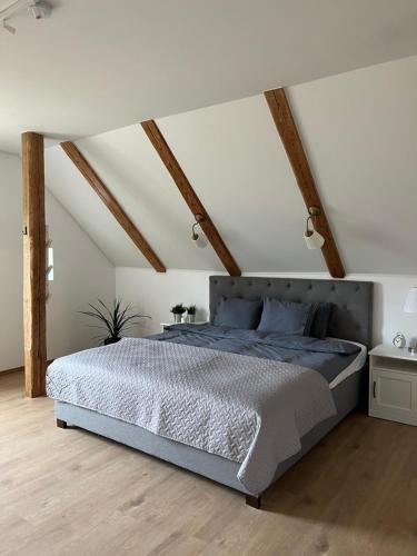 a bedroom with a large bed in a attic at Kreutzwaldi Kodu 2 in Võru