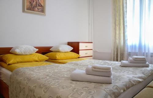 a bedroom with two beds with towels on them at Apartman Plitvice Happy Home in Plitvička Jezera