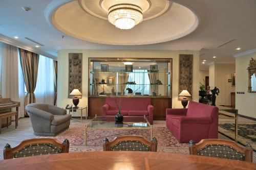 a hotel lobby with a table and chairs and a chandelier at Meliá Caracas in Caracas