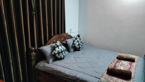 a bedroom with a bed with pillows on it at La maison de Soriya - Homestay in Kampot