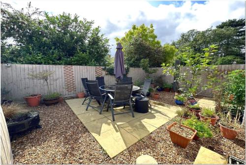 a patio with a table and chairs and an umbrella at Luxury apartment Old Compton St in London