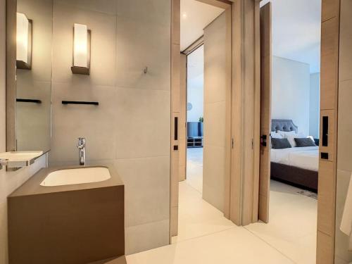 a bathroom with a sink and a bed at Key View - Address JBR in Dubai