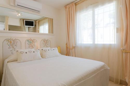 a bedroom with a large white bed with a window at Villa spa hamman sauna Piscine 9 chambres in Juan-les-Pins