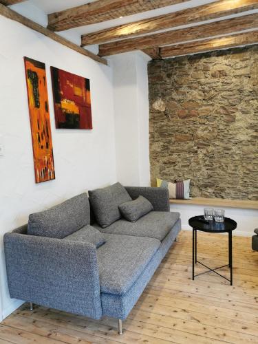 a living room with a couch and a table at Das Kirch24 - DAS Ferienhaus in Heidenburg in Heidenburg