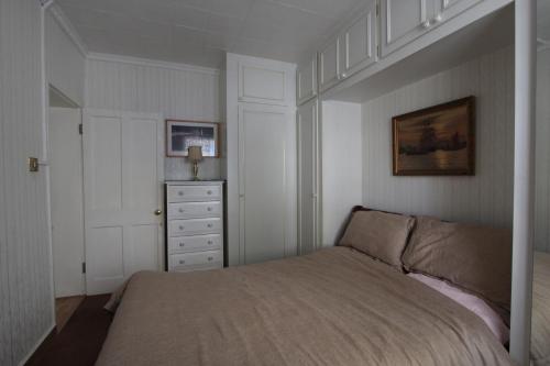 a bedroom with a bed and a dresser at Double room for rent in shared Covent Garden apartment in London