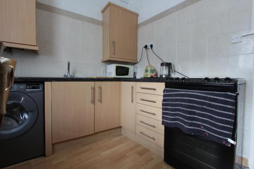 a kitchen with a washing machine and a washer at Double room for rent in shared Covent Garden apartment in London