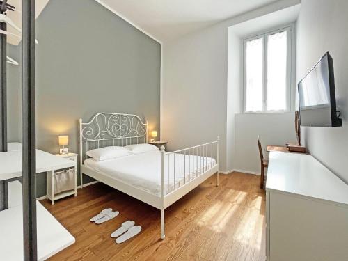 a bedroom with a bed and a desk and a mirror at "La Portineria" Charming Apartment Old Town Como Lake in Como