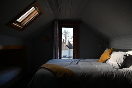 a attic bedroom with a bed with a window at Shelburne Hotel in Seaview
