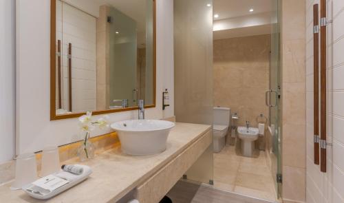 a bathroom with a sink and a toilet at Pestana Alvor Praia Premium Beach & Golf Resort in Alvor
