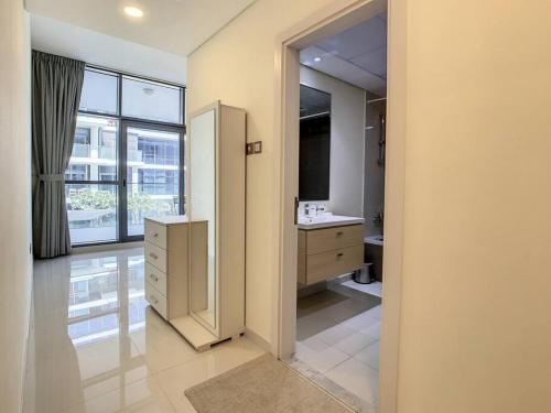 a bathroom with a sink and a large window at Key View - Loreto 3B, Damac Hills in Dubai Marina
