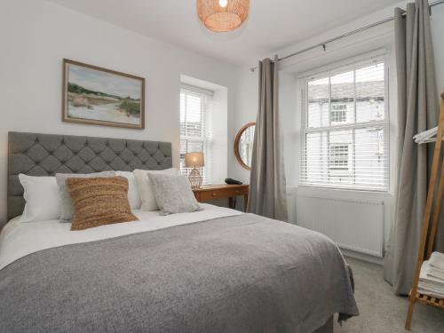 a bedroom with a large bed and a window at Rose Cottage in Ambleside