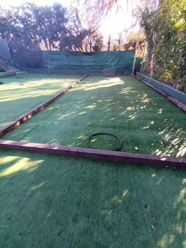 a tennis racket laying on a tennis court at Villa spa hamman sauna Piscine 9 chambres in Juan-les-Pins