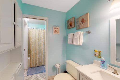 a bathroom with a toilet sink and a shower at Summit 723 in Panama City Beach