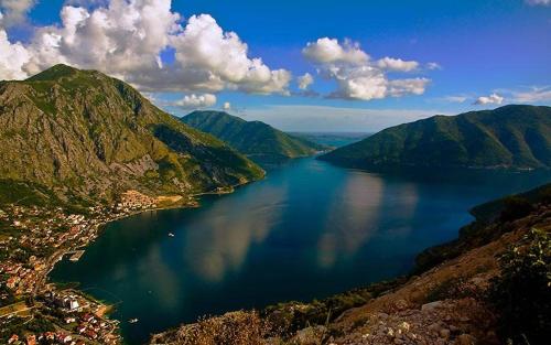 a view of a large body of water between mountains at Apartment R in Risan