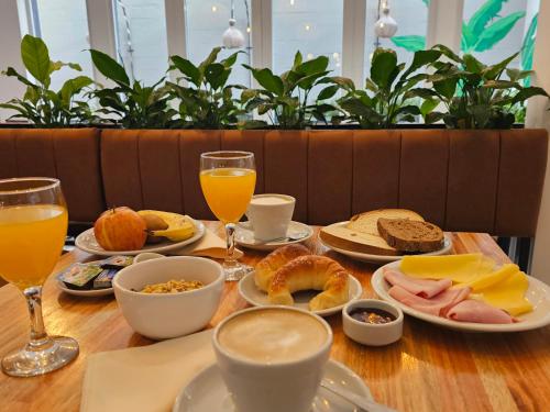 Una mesa con alimentos y bebidas para el desayuno. en HotelN26, en Mar del Plata