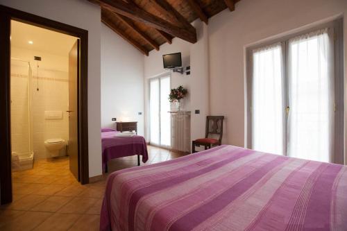 Postel nebo postele na pokoji v ubytování Hotel La Locanda