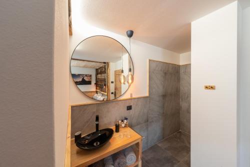 a bathroom with a sink and a mirror at Ciasa Marizana in Soraga