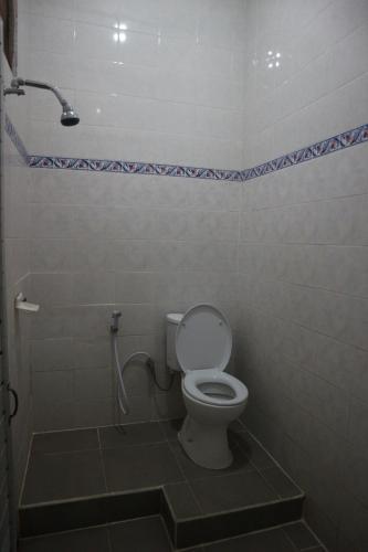 a bathroom with a toilet and a shower at Hotel Diana 1 in Denpasar