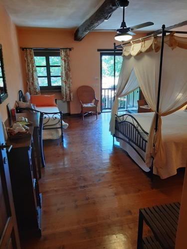 a bedroom with a bed with a canopy at La Collina dei Passeri in Pocapaglia