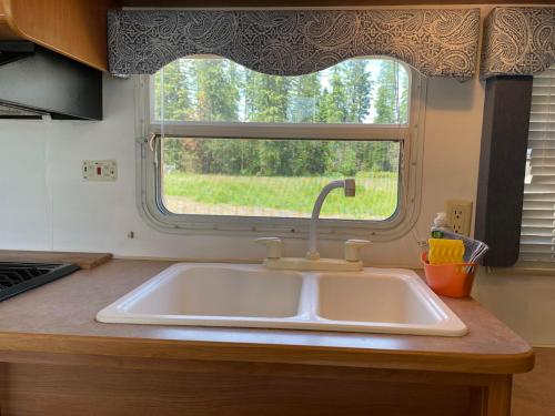 a sink in a kitchen with a window at Quiet Country Rimrock Retreat in Hayden