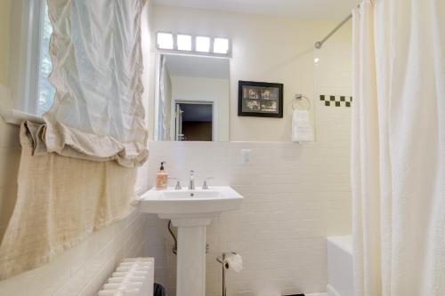 a white bathroom with a sink and a mirror at Silver Spring Rental 8 Mi to Washington, DC! in Silver Spring