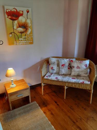 a living room with a couch with pillows and a table at La Collina dei Passeri in Pocapaglia