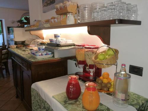 a kitchen with a table with a basket of fruit at Hotel La Locanda in Stresa