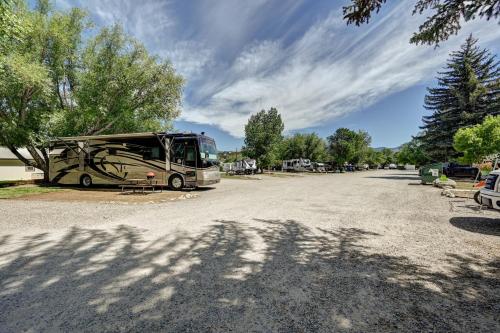 a bus parked on the side of a road at Snowy Peaks RV Park in Buena Vista