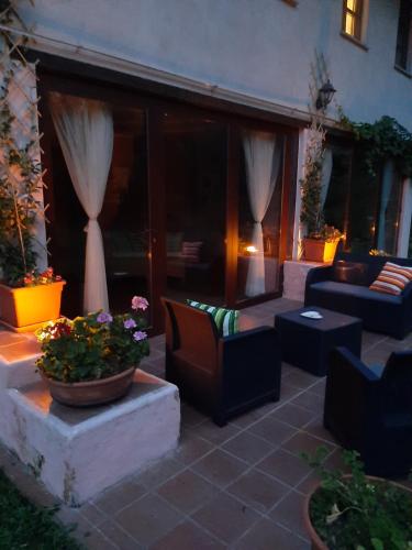 a patio with couches and a table and chairs at La Collina dei Passeri in Pocapaglia