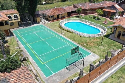 an overhead view of a tennis court in front of a house at Quinta San Martín in Cuenca