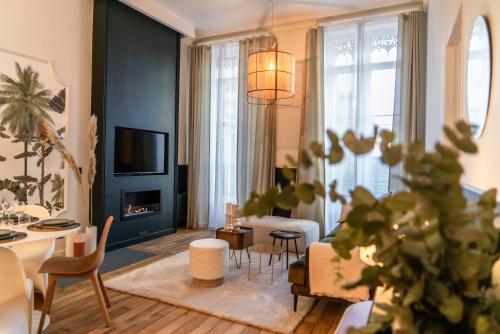 a living room filled with furniture and a fireplace at Coco: hypercentre-2chambres-parking-zen... in Saint-Étienne