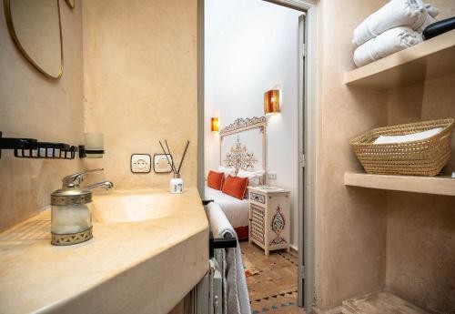 a bathroom with a sink and a mirror at Riad La Croix Berbere in Marrakech