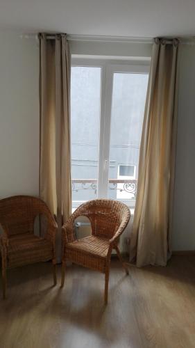 a living room with two chairs and a window at central studio close to grand place for 2 in Brussels