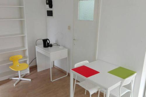 a room with a table and a desk and a chair at central studio close to grand place for 2 in Brussels