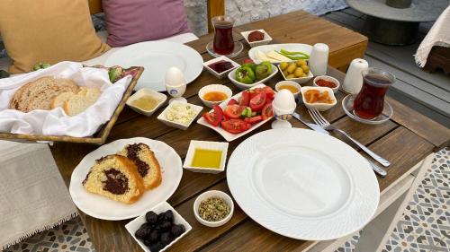 a wooden table with plates of food on it at Macide Hanım Konağı in Ayvalık