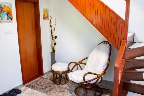 a room with a chair and a staircase at VillaH Weekend House in Visoko