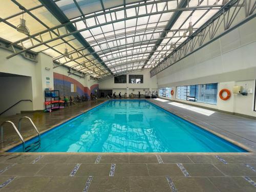 a large indoor swimming pool with a ceiling at Dann Carlton Quito in Quito