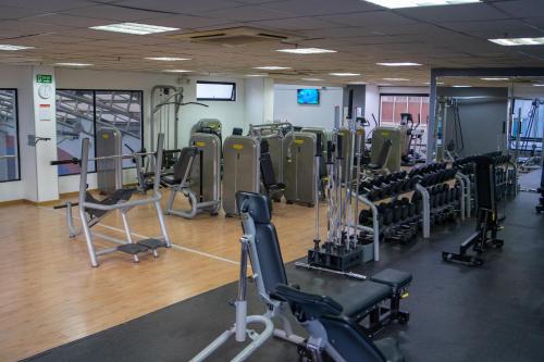 a gym with treadmills and exercise equipment in it at Dann Carlton Quito in Quito