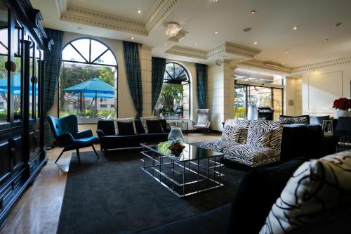 a lobby with couches and chairs and a table at Dann Carlton Quito in Quito